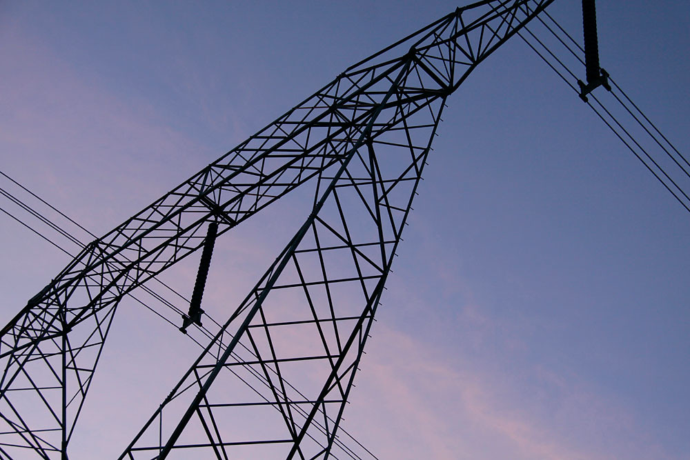 Power grid infrastructure towers — the energy backbone that AI compute depends on