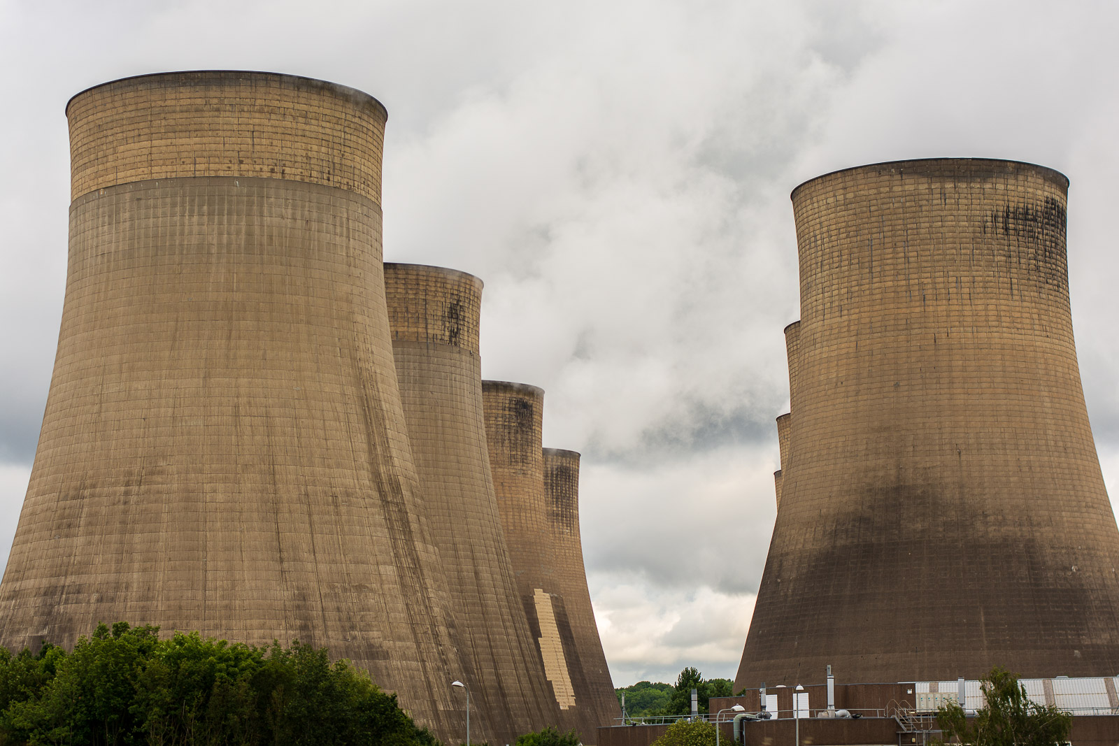 Power station cooling towers — the visible symbol of the electricity infrastructure that data centers are consuming at unprecedented scale during the AI buildout